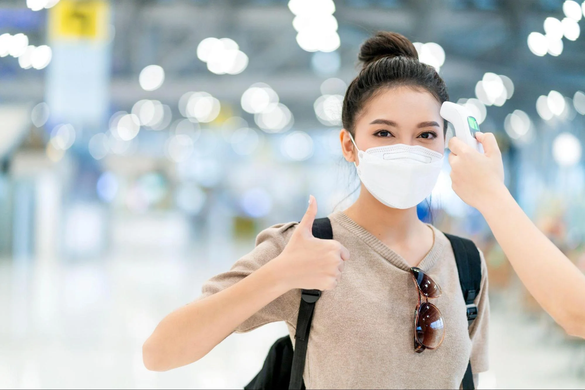 female traveler undergoing temperature check