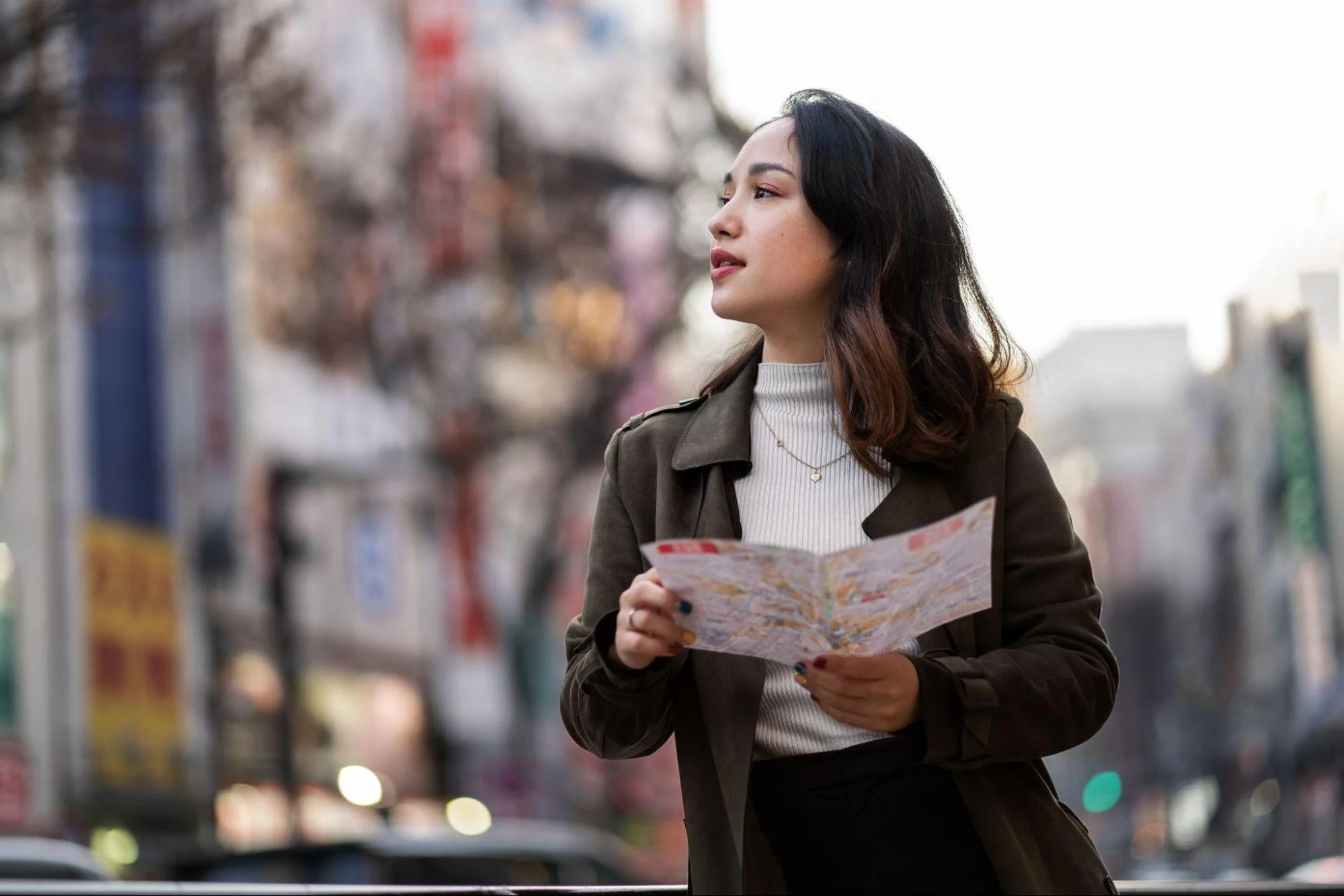 Young woman traveling alone with a map